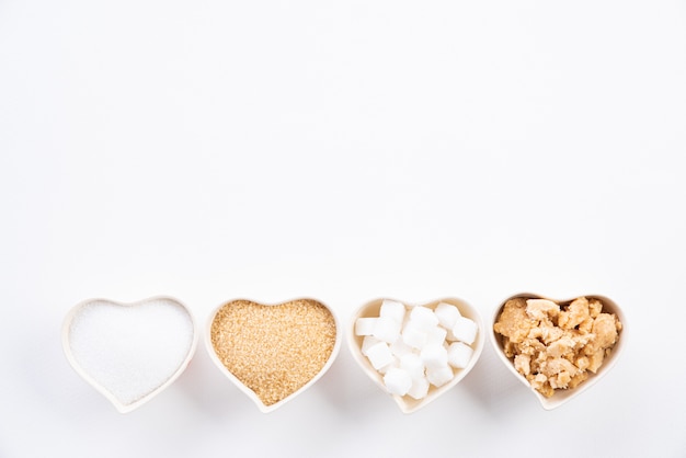 Top view of various types of sugar on white