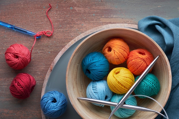 Top view of various yarn balls and latch hook