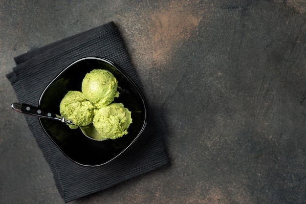 top view of vegan avocado ice cream in black bowl clean eating concept