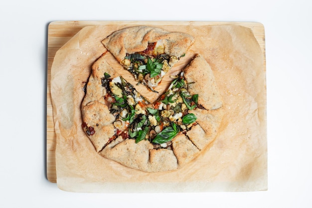 Top view of vegan galette on parchment paper White background Homemade food