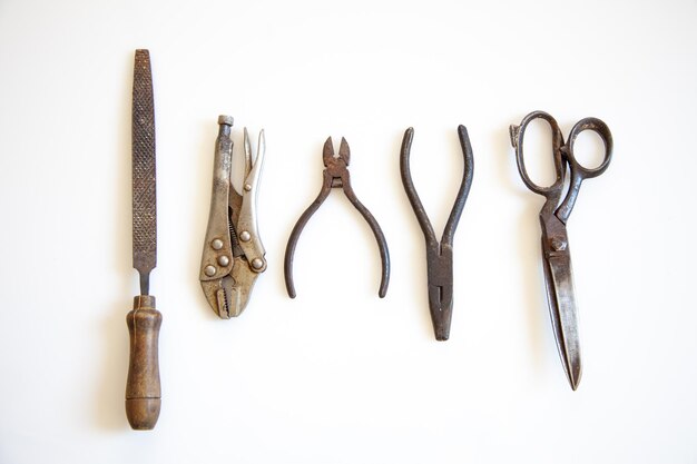 Top view of vintage metalwork tools isolated on a white background