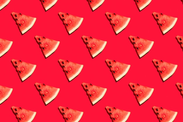 Top view of watermelon slices on red background. Watermelon colorful pattern.