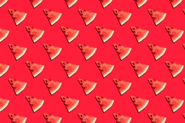 Top view of watermelon slices on red background. Watermelon colorful pattern.