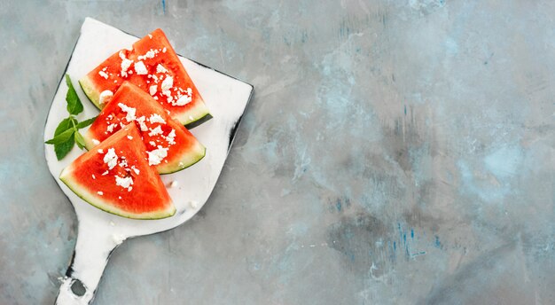 Top view of watermelon slices on white board