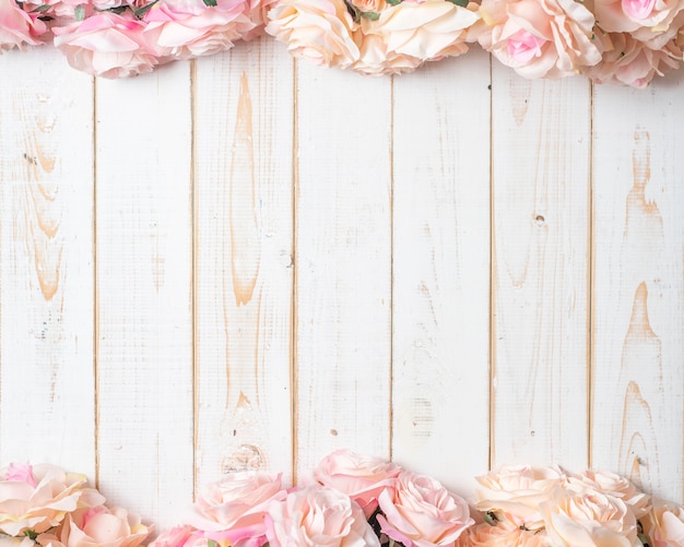 Top view of wedding flowers on white wood background 