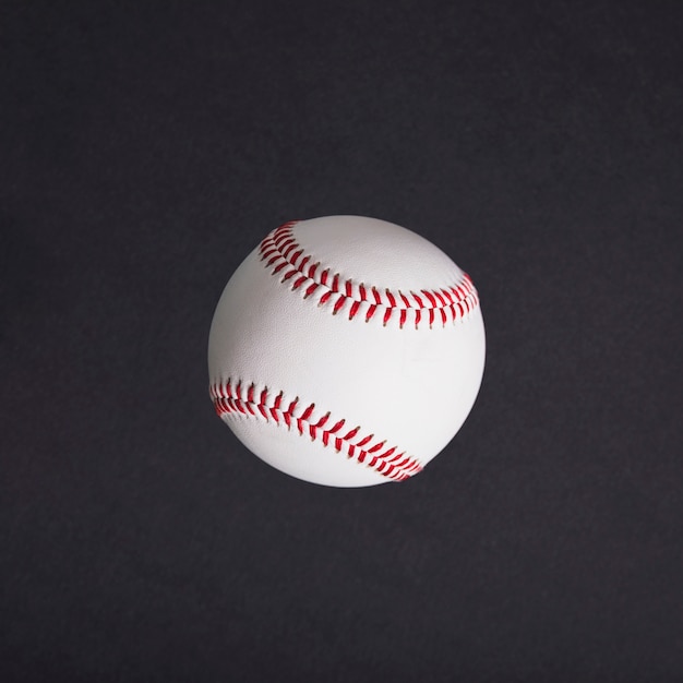 Top view of white baseball on black background