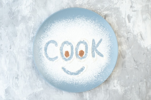 Top view white flour making cook writing inside plate on white\
background cake bake egg color cook pie photo food dust