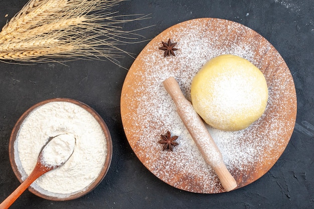 Top view white flour with dough on dark background raw food bake flour color