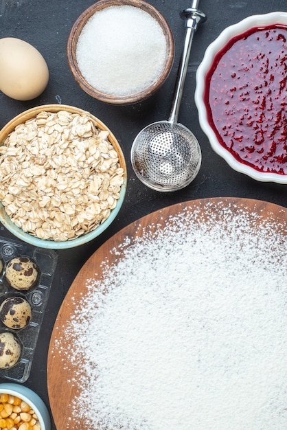 top view white flour with nuts seeds cereals raisins and jelly on dark background breakfast color dough cake pie dust bake