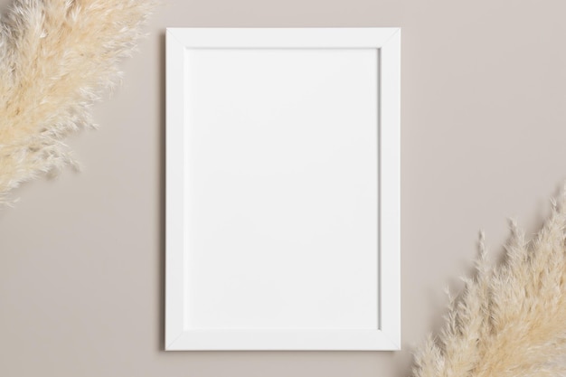 Top view of a white frame mockup with pampas decoration