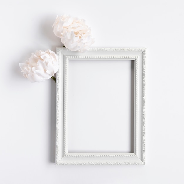 Photo top view white frame with flowers