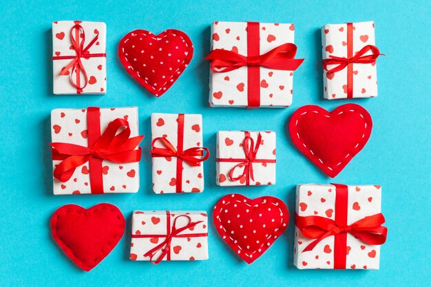 Top view of white gift boxes and red textile hearts. Valentine's Day concept