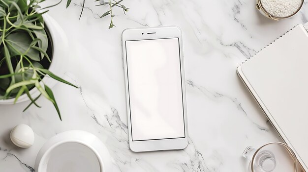 Photo top view of a white marble table with a smartphone a notebook a plant and other office supplies