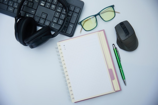 Photo top view of a white office desk with a notebook