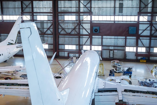 Top view of a white passenger airplanes in the hangar Airliners under maintenance