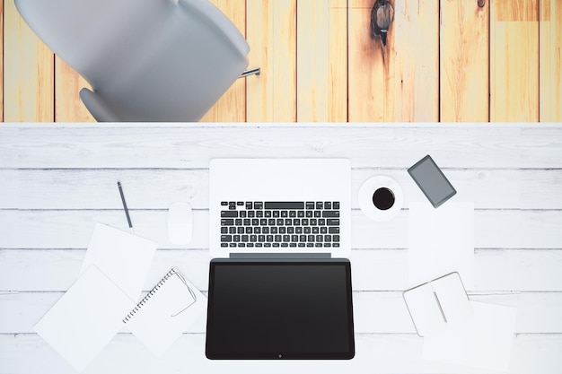 Top view of a white wooden desk with blank laptop screen mock
up