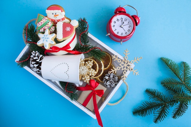 Top view of white wooden tray with Christmas presents on the blue background Copy space