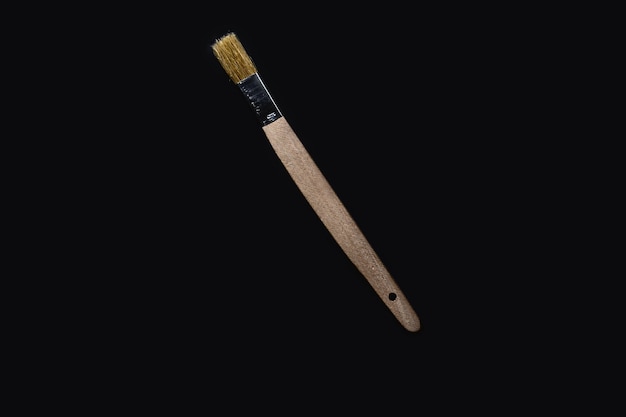 top view of whitewashing brush on black background