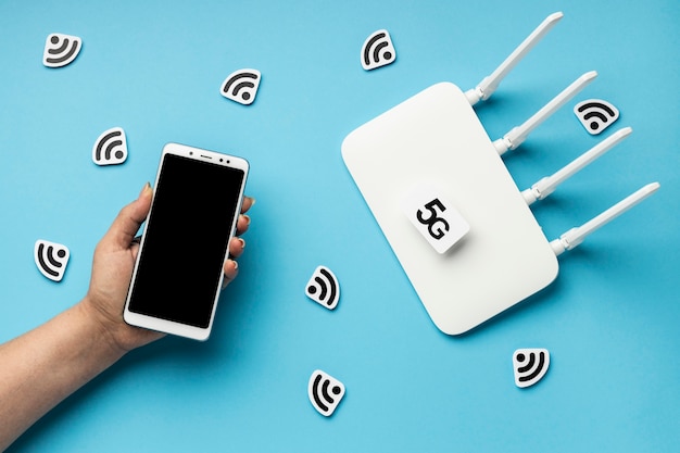 Photo top view of wi-fi router with smartphone and 5g symbol