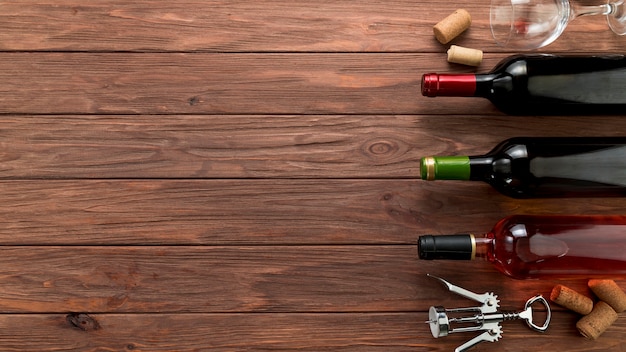 Top view wine bottles line on wooden background