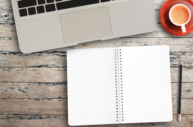 Top view with glasses and notebook on wood table background in office workplace