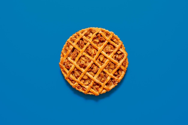 Top view with a homemade apple pie isolated on a blue background Freshly baked lattice crust cake with apple filling