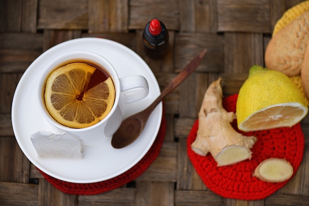 Top view with hot tea with lemon, ginger and propolis drops