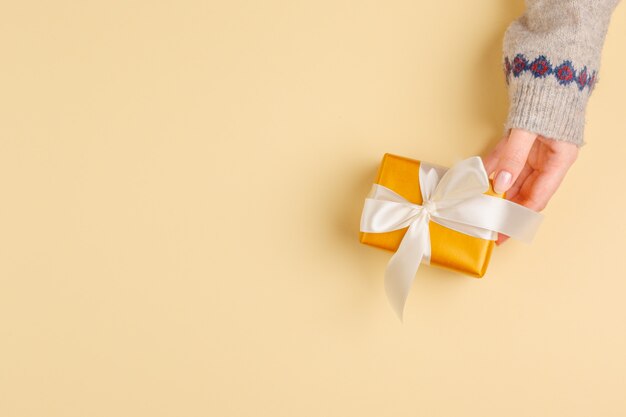 Top view of woman hands holding gift box