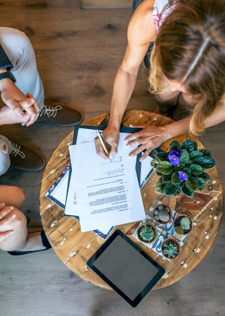 Top view of woman signing a document