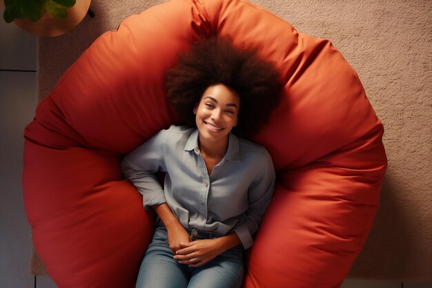 Photo top view of woman sitting on bean bag at home in living room