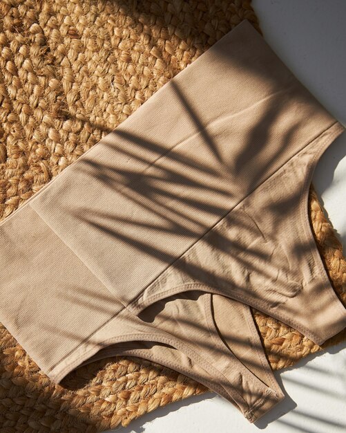 Top view women's cotton body color panties isolated on sunny white Flat lay