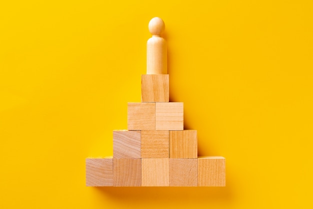 Top view of wooden cubes on yellow background