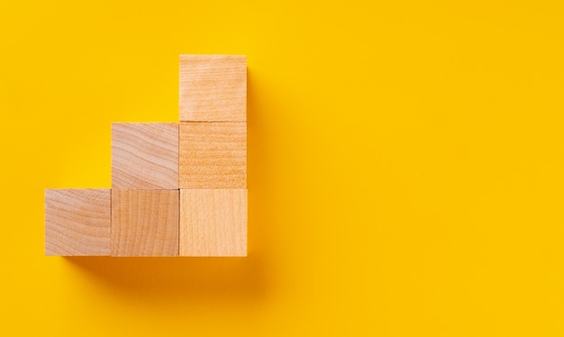 Top view of wooden cubes on yellow