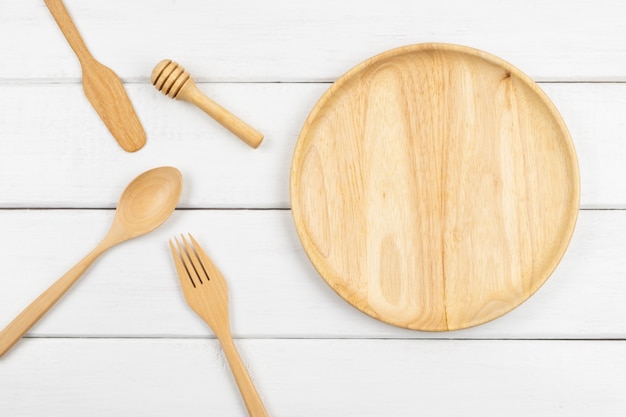 Top view of a wooden dish with eating utensils