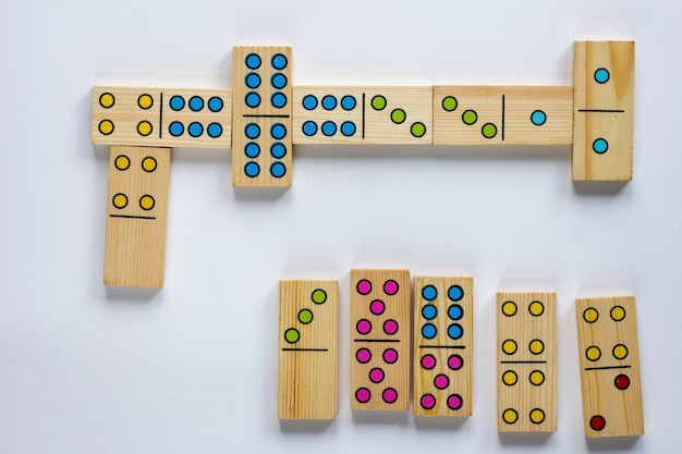 Top view of wooden dominoes gaming pieces on the white background