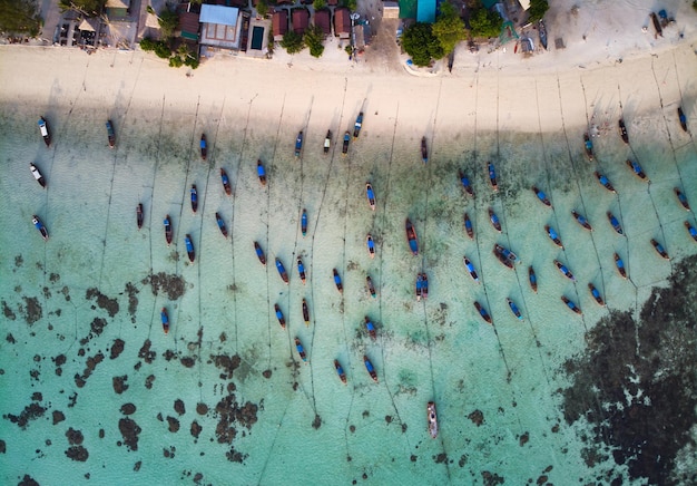 Top view of wooden long-tail boat anchored on coastline in tropical sea at Lipe island