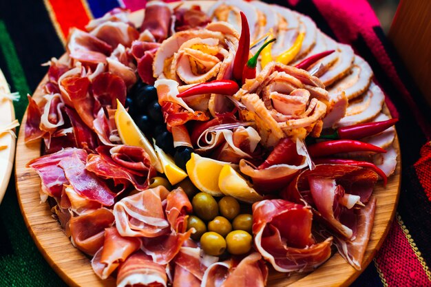 Top view on a wooden plate with slices of bacon