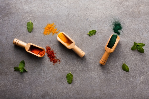 Top view wooden spoons with aromatic spices