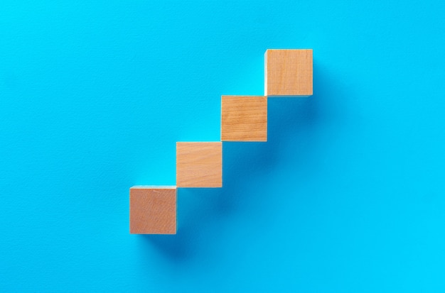 Top view of wooden toy blocks on blue