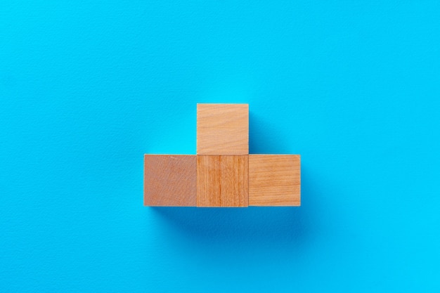 Top view of wooden toy blocks on blue