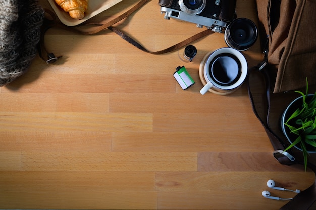 Top view of wooden workplace of photographer and copy space