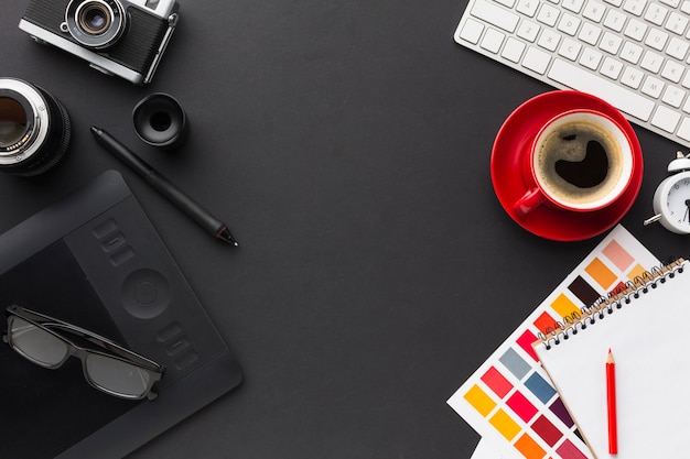 Top view of work desk with coffee and drawing pad