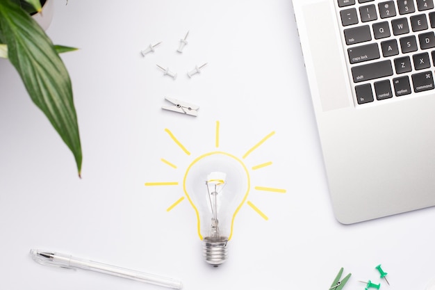 Top view on working place with yellow lamp as a symbol of idea
coming creativity