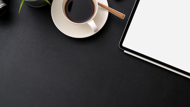 Top view of workplace with digital tablet, coffee cup and copy space