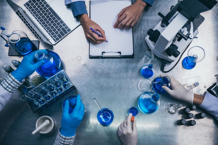 Photo top view workspace in laboratory with microscope, laptop, and laboratory tools