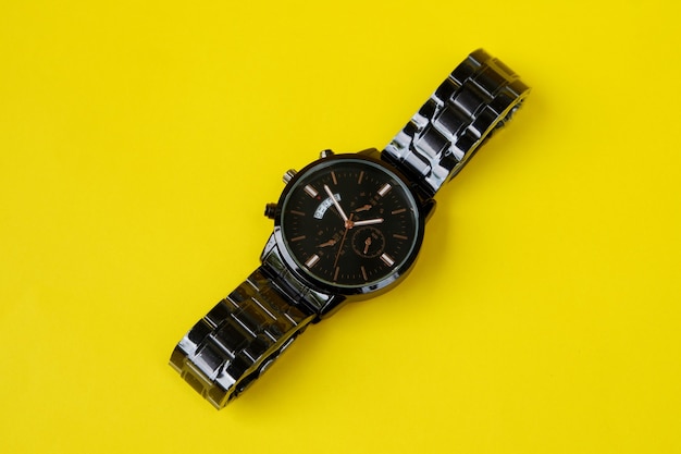 Top view of wrist watch isolated on yellow background