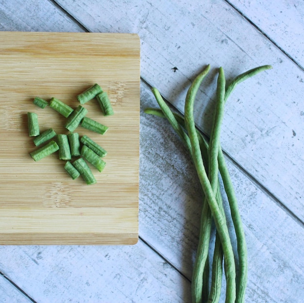 Top view of yardlong beans on wooden chopping board