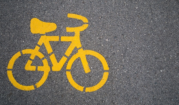 Top - view,Yellow bike symbol on the street in Urban city