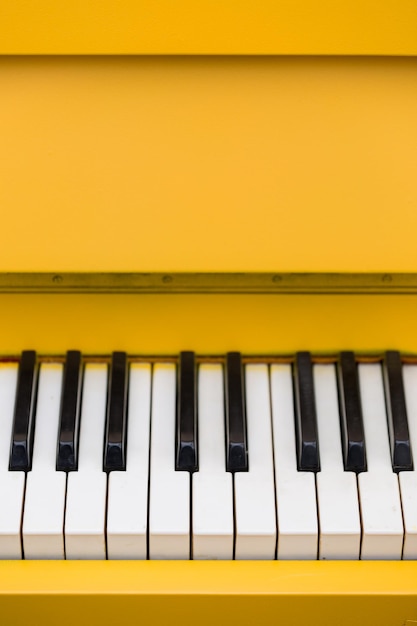 Photo top view on yellow piano closeup of piano keys music concept