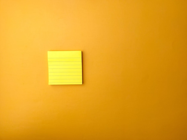 Photo top view yellow sticky note on a yellow background